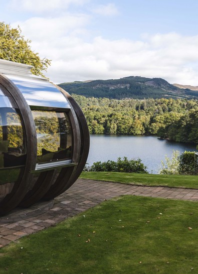 View of loch and pine trees from a dining pod at Fonab Castle Luxury Hotel Scotland  ?? ''