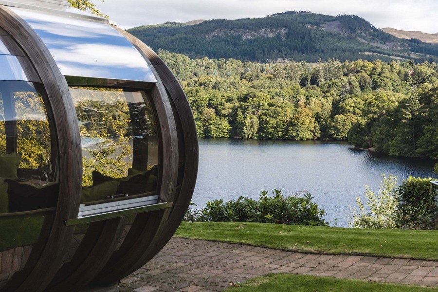 View of loch and pine trees from a dining pod at Fonab Castle Luxury Hotel Scotland  ?? ''